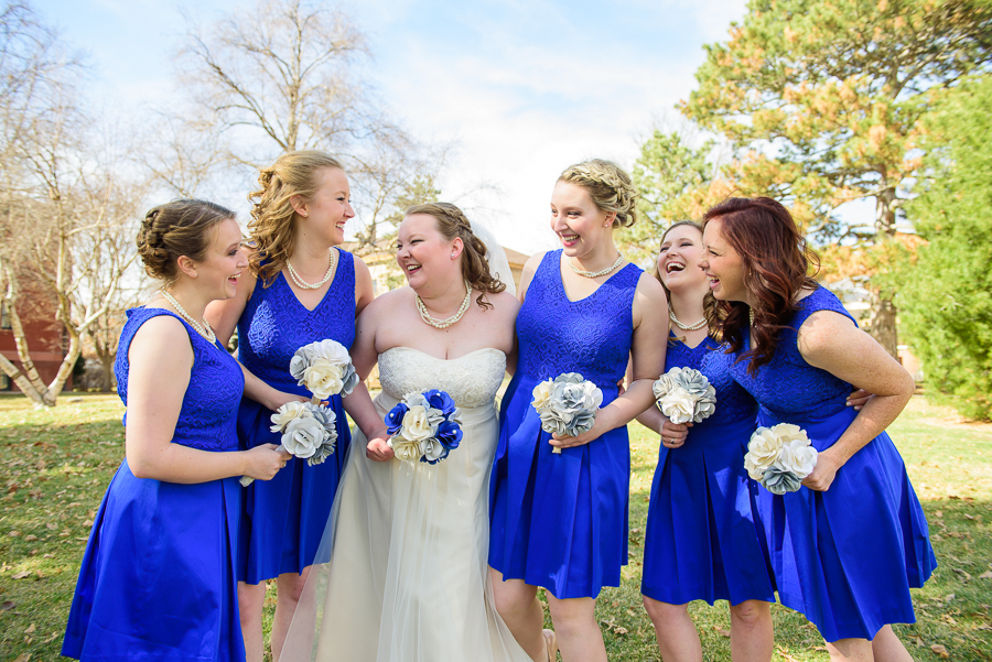Bridesmaids in bright blue laughing